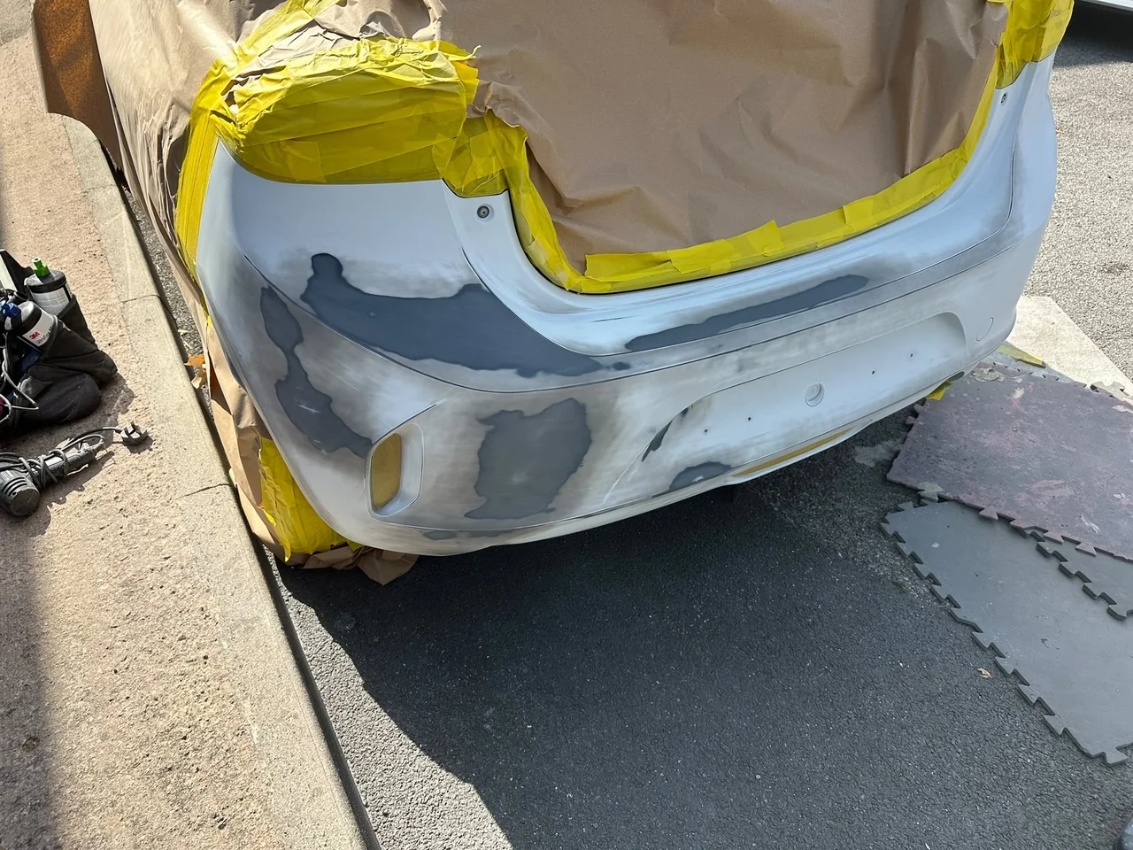White rear bumper prepared for cosmetic repair by Vehicle Repair Experts